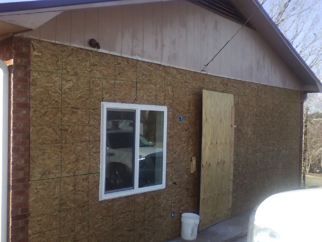 OSB sheathing on a garage addition wall before siding in Auburndale
